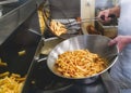 Frying French fries, Chips, Frites with double fry technique.